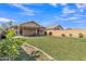 Expansive backyard offers a covered patio and vast green space, perfect for outdoor enjoyment at 12605 W Dreyfus Dr, El Mirage, AZ 85335
