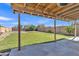 Enjoy outdoor living on the covered patio overlooking a well-maintained backyard with mature trees at 12605 W Dreyfus Dr, El Mirage, AZ 85335