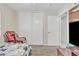 Another view of the bedroom showing a red chair and closet doors at 12605 W Dreyfus Dr, El Mirage, AZ 85335