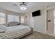 Final view of the bedroom shows more windows and a mounted tv at 12605 W Dreyfus Dr, El Mirage, AZ 85335