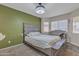 Another view of the bedroom featuring a grey headboard and windows at 12605 W Dreyfus Dr, El Mirage, AZ 85335