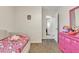 Bright bedroom features playful decor, neutral walls, and easy access to an adjoining room at 12605 W Dreyfus Dr, El Mirage, AZ 85335