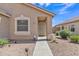 Exterior image of a house entrance with a security door and landscaped yard at 12605 W Dreyfus Dr, El Mirage, AZ 85335