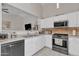 Bright kitchen features stainless steel appliances, white cabinets, and tile flooring at 12605 W Dreyfus Dr, El Mirage, AZ 85335