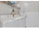 Efficient laundry room boasts modern washer and dryer with ample shelving for storage at 12605 W Dreyfus Dr, El Mirage, AZ 85335