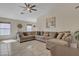 Spacious living room with neutral tones, tile flooring, and large sectional couch at 12605 W Dreyfus Dr, El Mirage, AZ 85335