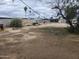 Large backyard with dirt, a small shack for animals, and decorative lighting, perfect for outdoor living at 12607 N 23Rd St, Phoenix, AZ 85022