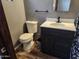 This bathroom features a toilet and a dark vanity with drawers and a white countertop, offering style and functionality at 12607 N 23Rd St, Phoenix, AZ 85022