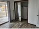 Bedroom with sliding mirrored closet doors, hardwood floors, and a glass door to the outdoors at 12607 N 23Rd St, Phoenix, AZ 85022