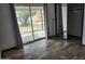 Bedroom with wood floors, closet, and sliding doors that lead to the backyard at 12607 N 23Rd St, Phoenix, AZ 85022
