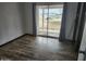 Bedroom with wood floors, closet, and sliding doors that lead to the backyard at 12607 N 23Rd St, Phoenix, AZ 85022