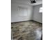 Small bedroom with wood floors, dual windows, ceiling fan, and white paint at 12607 N 23Rd St, Phoenix, AZ 85022