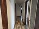 Hallway with faux wood flooring and doors leading to the bathroom and pantry at 12607 N 23Rd St, Phoenix, AZ 85022