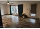 Spacious living room with wood floors, large window, ceiling fan, and door to the exterior at 12607 N 23Rd St, Phoenix, AZ 85022