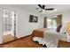 Bedroom featuring terracotta tile flooring, TV, ceiling fan and a sliding glass door at 13034 N 69Th St, Scottsdale, AZ 85254