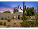 A classic desert home featuring native vegetation and dramatic desert landscaping at 13034 N 69Th St, Scottsdale, AZ 85254