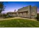 Exterior of home features mature landscaping, sport court, and patio seating at 13034 N 69Th St, Scottsdale, AZ 85254