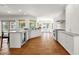 Bright kitchen with an island bar, white cabinets, brick floors, and stainless steel appliances at 13034 N 69Th St, Scottsdale, AZ 85254