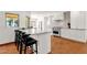 Modern kitchen with an oversized island, stainless appliances, and tile backsplash at 13034 N 69Th St, Scottsdale, AZ 85254