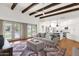 Open concept living room, kitchen and backyard with exposed wood beams, terra-cotta floors, and ample sunlight at 13034 N 69Th St, Scottsdale, AZ 85254