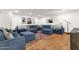 Spacious living room with a large sectional sofa, ottomans, and patterned rug at 13034 N 69Th St, Scottsdale, AZ 85254