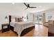 Spacious main bedroom featuring a king bed, fan, and French doors with a pool view at 13034 N 69Th St, Scottsdale, AZ 85254