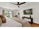 Bright main bedroom with a king bed, modern ceiling fan, and an exterior view at 13034 N 69Th St, Scottsdale, AZ 85254