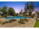 Lush backyard with pool, jacuzzi, waterslide, and stone landscaping at 13034 N 69Th St, Scottsdale, AZ 85254