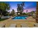 A backyard pool and spa are surrounded by lush landscaping at 13034 N 69Th St, Scottsdale, AZ 85254