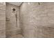 Close-up of shower featuring light tan brick, shower head and a built-in bench at 13034 N 69Th St, Scottsdale, AZ 85254