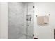 Modern shower with gray and white marble tiles and a glass door at 13034 N 69Th St, Scottsdale, AZ 85254