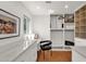 Bright walk-in closet featuring white cabinets, terracotta tile flooring and desk space with window at 13034 N 69Th St, Scottsdale, AZ 85254