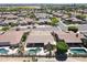 Aerial view of home with pool in gated golf course community at 13458 W Coronado Rd, Goodyear, AZ 85395