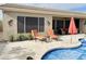Relaxing backyard with a pool, patio furniture, and desert landscaping at 13458 W Coronado Rd, Goodyear, AZ 85395