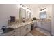 Lovely bathroom with dual sinks, granite countertops, and modern light fixtures at 13458 W Coronado Rd, Goodyear, AZ 85395