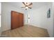 Bright bedroom with foldaway bed and light, wooden floor at 13458 W Coronado Rd, Goodyear, AZ 85395