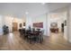 Spacious dining room with a large table, modern lighting, and wood-look tile flooring at 13458 W Coronado Rd, Goodyear, AZ 85395