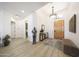 Inviting foyer with a stylish light fixture, wood-look tile flooring, and decorative accents at 13458 W Coronado Rd, Goodyear, AZ 85395