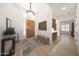 Inviting foyer with a stylish light fixture, wood-look tile flooring, and decorative accents at 13458 W Coronado Rd, Goodyear, AZ 85395