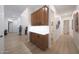 Hallway with wood cabinets, neutral paint, wood-look tile flooring and easy access to other rooms at 13458 W Coronado Rd, Goodyear, AZ 85395