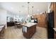 Open-concept kitchen with island and attached breakfast area and seamless transition to the Gathering room at 13458 W Coronado Rd, Goodyear, AZ 85395