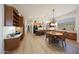 Full kitchen and dining area featuring granite counters, wood floors and cabinets, and plentiful natural light at 13458 W Coronado Rd, Goodyear, AZ 85395