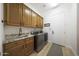 Laundry room with cabinetry, sink and granite countertops at 13458 W Coronado Rd, Goodyear, AZ 85395