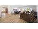 Open-concept living room with a dining area, large windows, and wood-look tile floors at 13458 W Coronado Rd, Goodyear, AZ 85395
