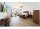 Large main bedroom boasts exercise equipment, view and hardwood floors at 13458 W Coronado Rd, Goodyear, AZ 85395