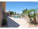 Gorgeous backyard oasis with a sparkling pool, patio, and lush landscaping at 13458 W Coronado Rd, Goodyear, AZ 85395