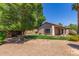 Backyard with a covered patio and mature trees at 1424 W Mead Dr, Chandler, AZ 85248