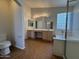 Bright bathroom featuring double sinks, vanity lighting, and a separate shower and tub at 1424 W Mead Dr, Chandler, AZ 85248