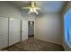 Bright bedroom featuring a ceiling fan, carpeted floors, and closet for ample storage at 1424 W Mead Dr, Chandler, AZ 85248