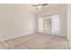 Bright bedroom with neutral carpet, vaulted ceilings, and a large window providing natural light at 1424 W Mead Dr, Chandler, AZ 85248